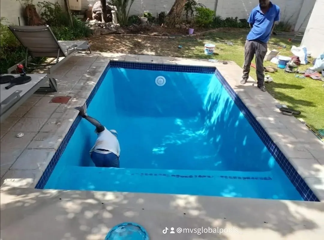 After: the finished freeform pool on its red-brick patio