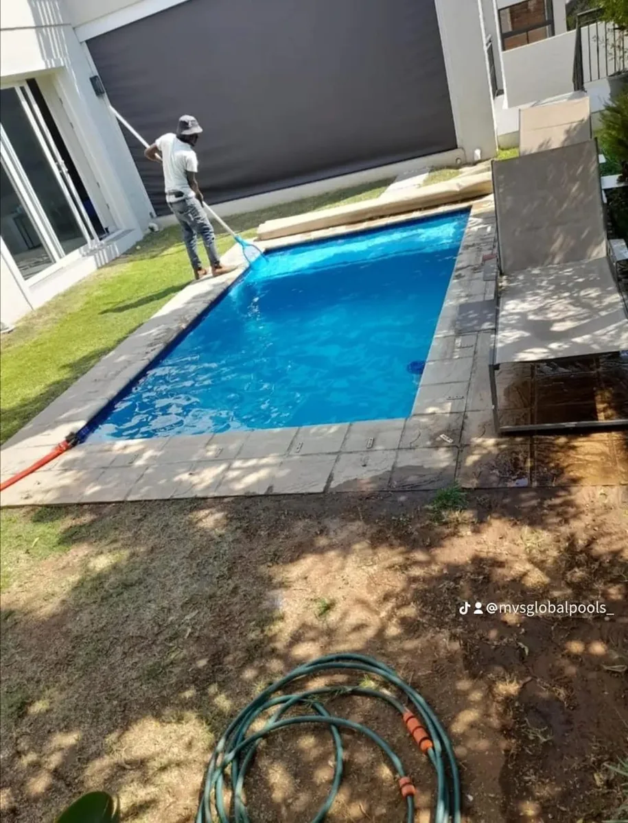 Team member netting a finished blue pool