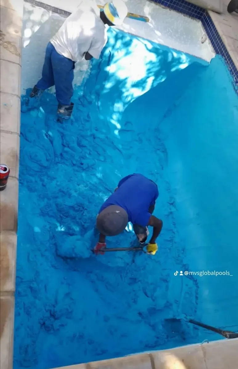 Two team members applying blue Marbelite, view from above