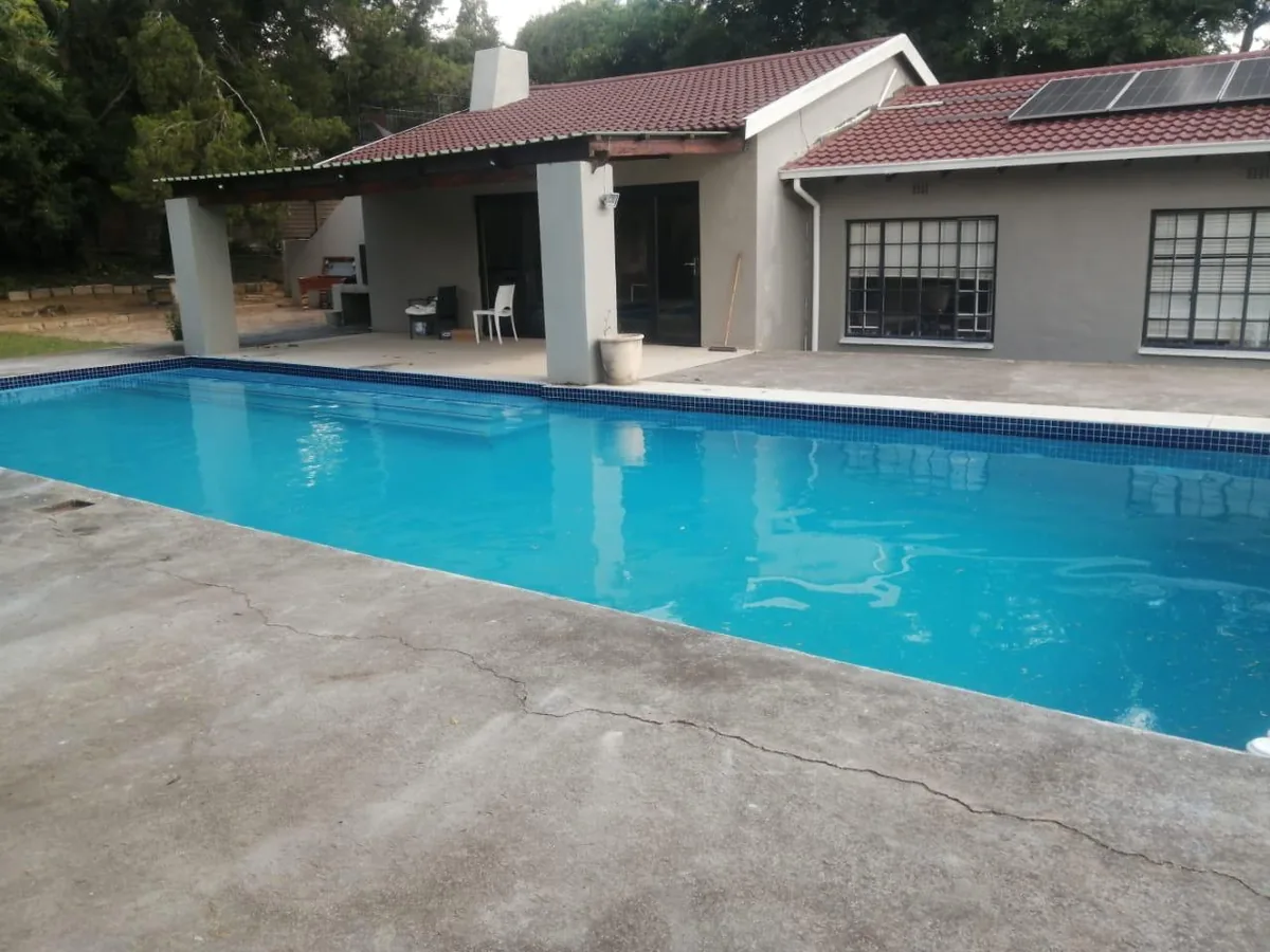 Long lap-style pool alongside a family home