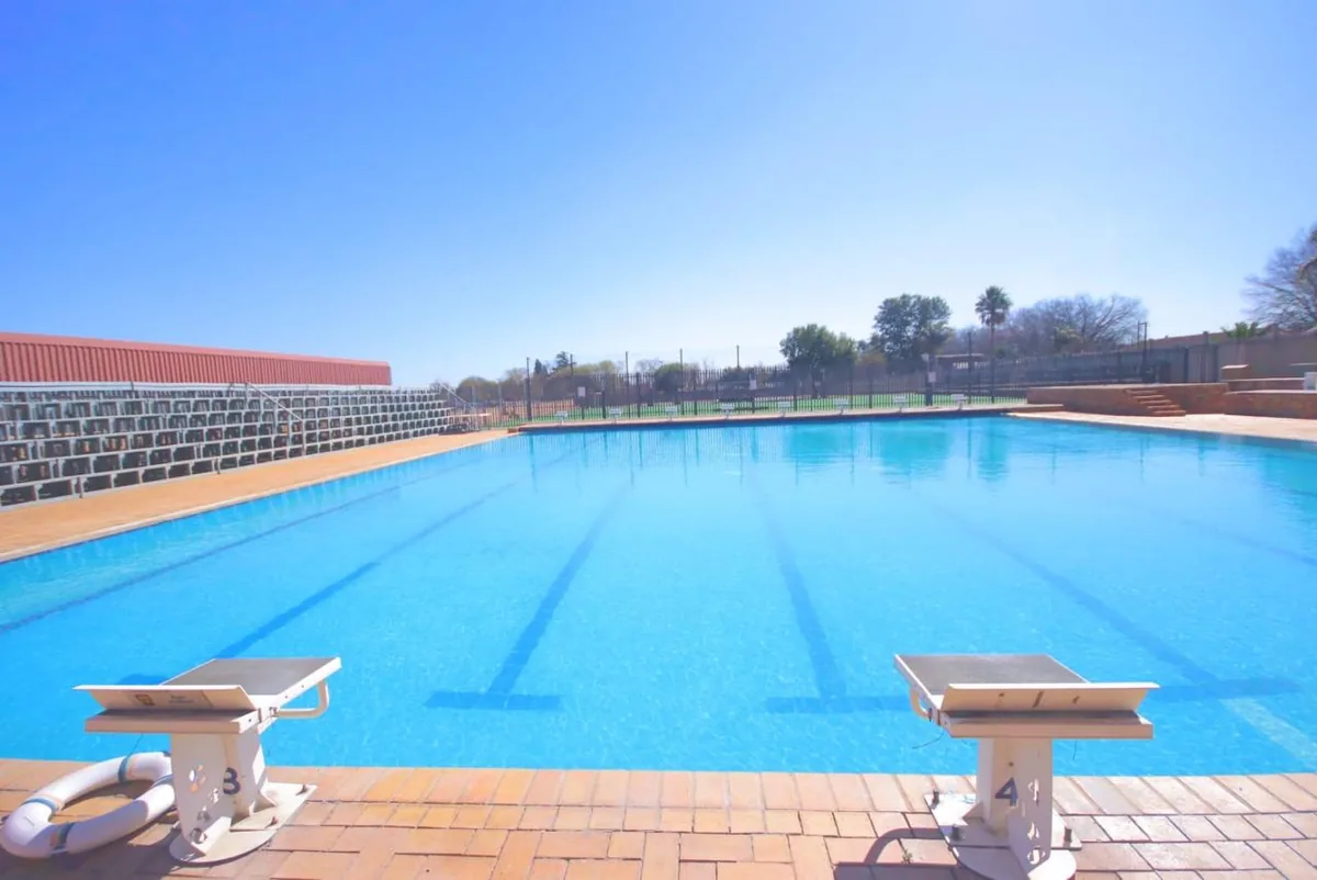 Large blue competition lap pool with starting blocks