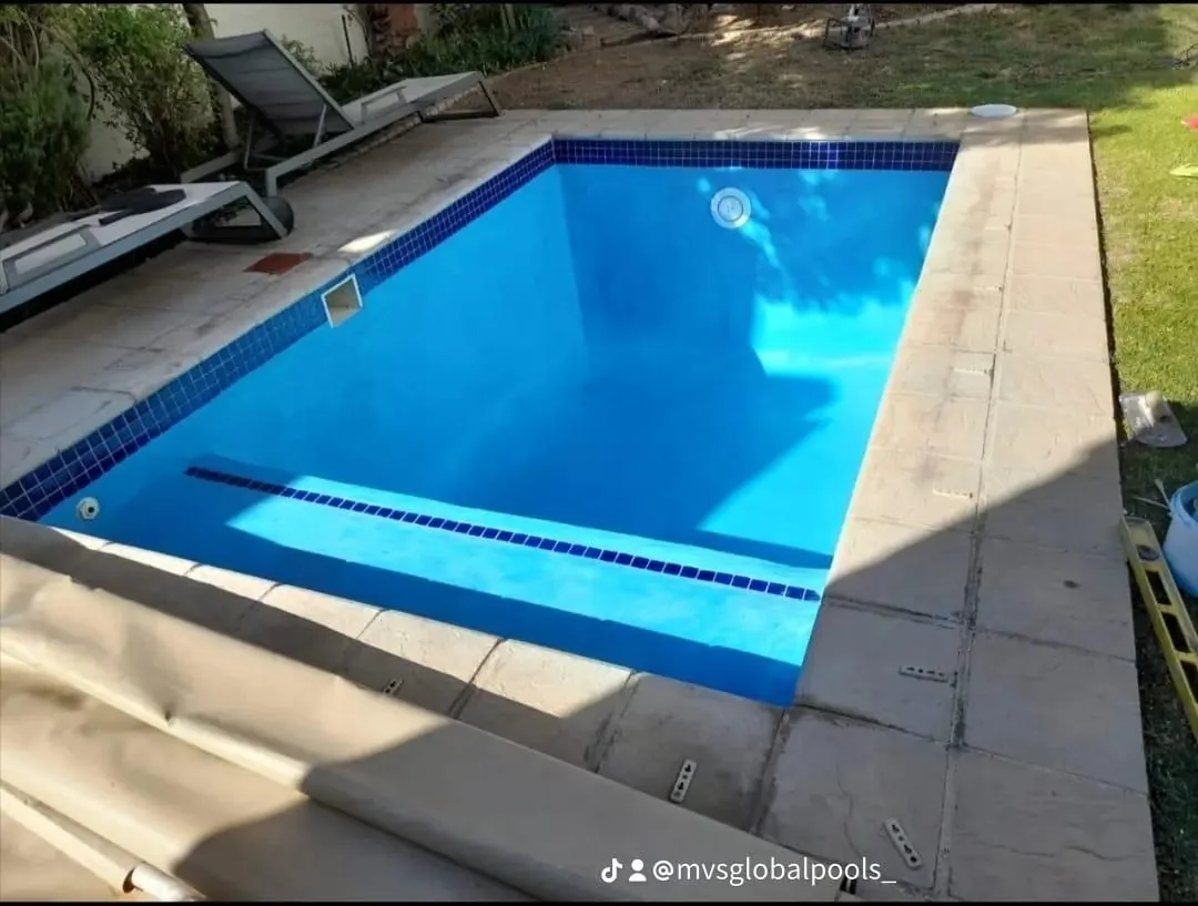Home pool finished in blue Marbelite with loungers alongside