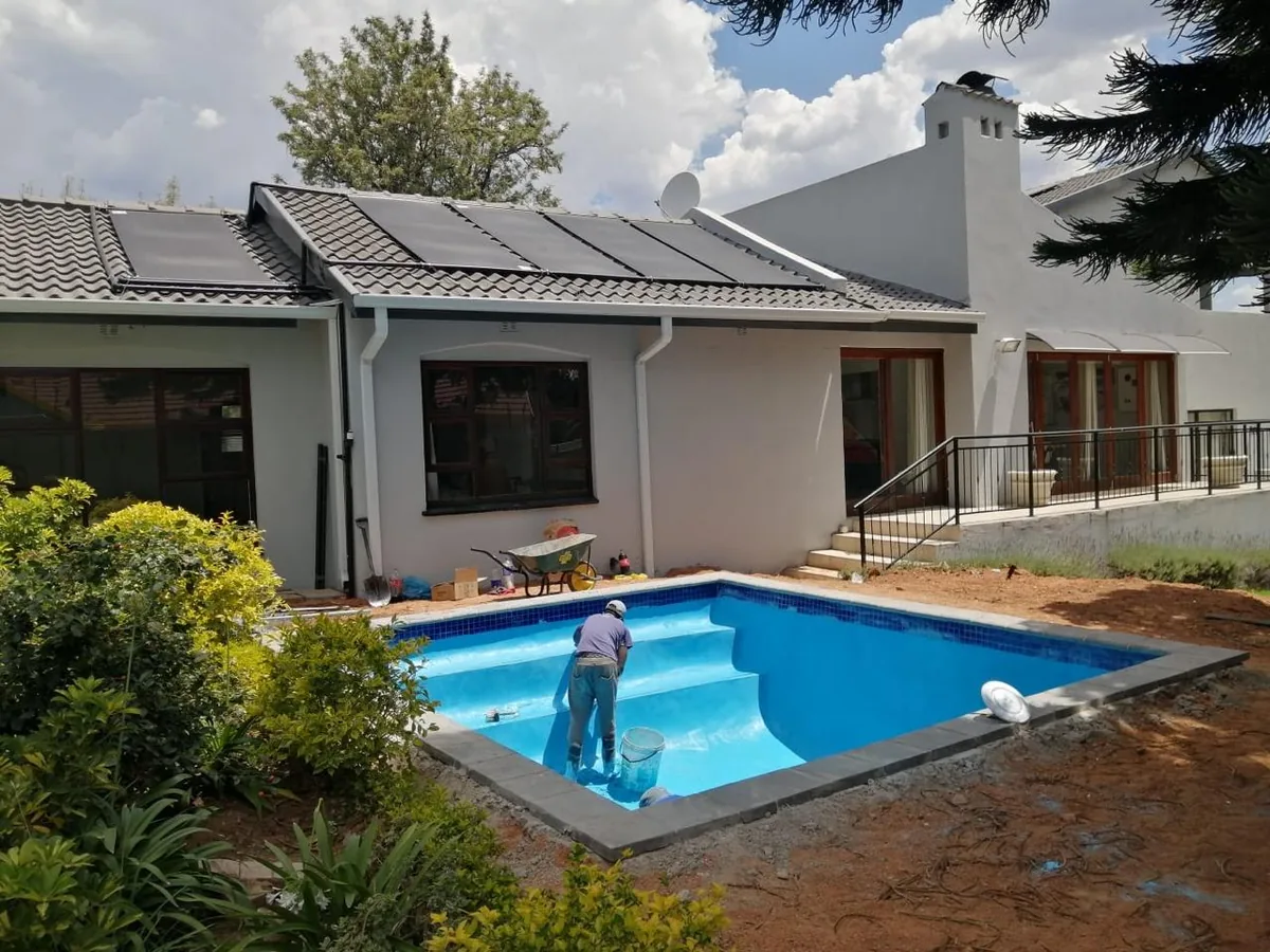 Team member applying blue Marbelite to pool steps