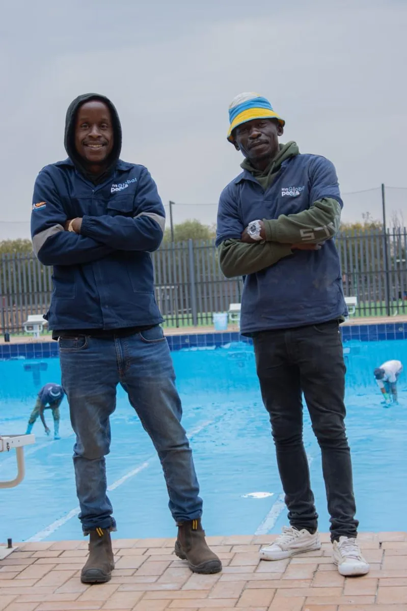 Two members of the MVS Global Pools team on site at a finished pool